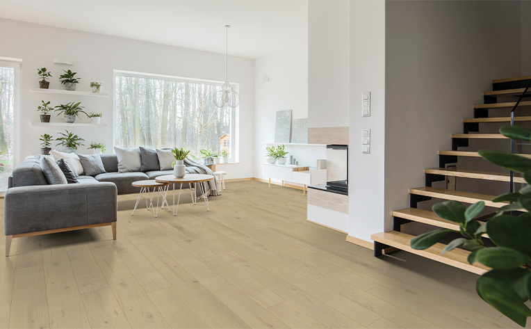 hardwood flooring in basement living room with stairs