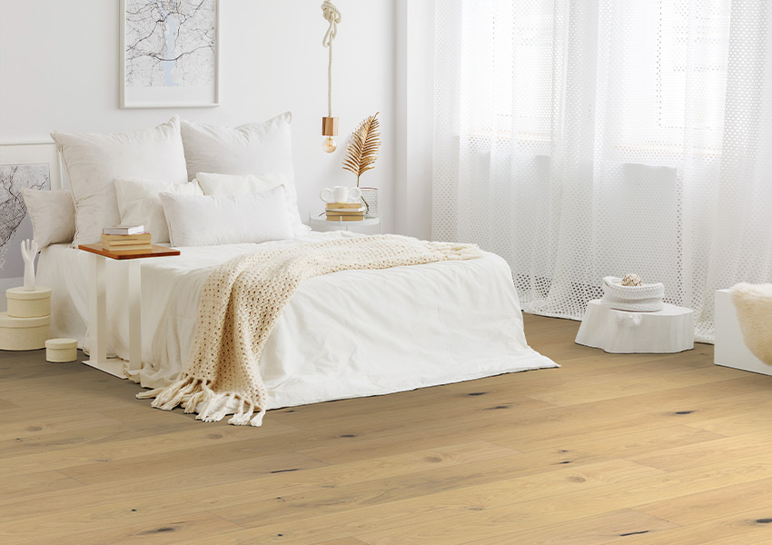 light hardwood flooring in bedroom with boho decor
