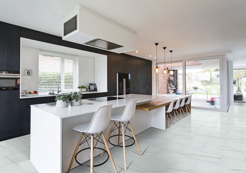 luxury vinyl tile flooring in kitchen with black cabinets and white kitchen island.